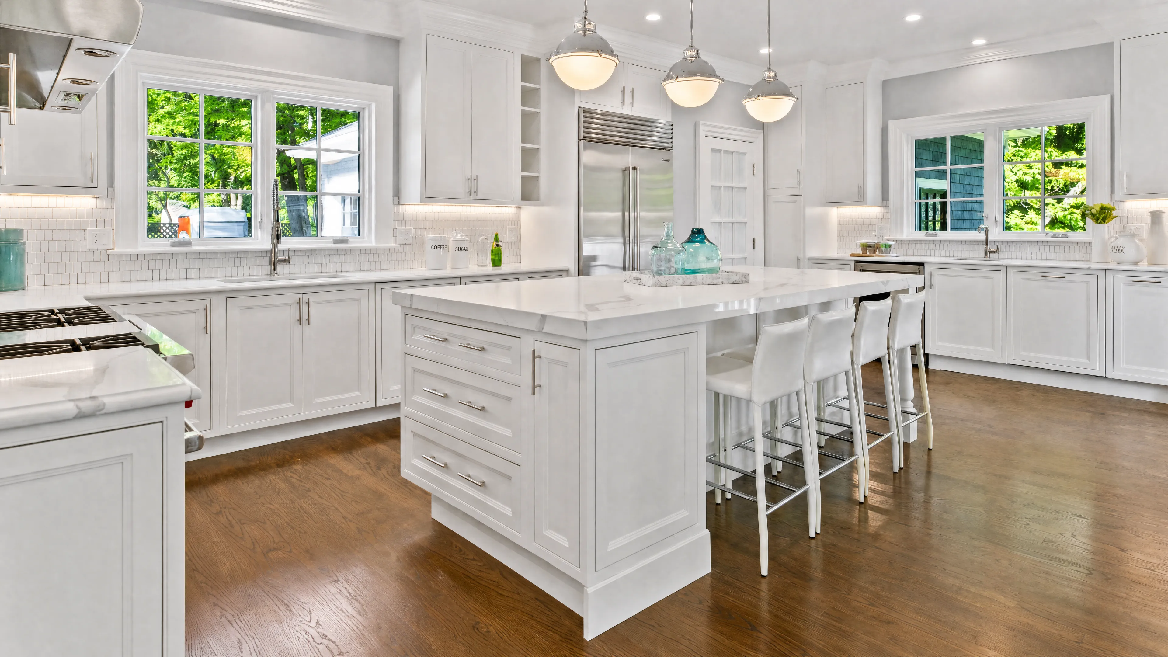Bright, custom-renovated kitchen with marble island, a recent Abrams Builders project in Greater Boston