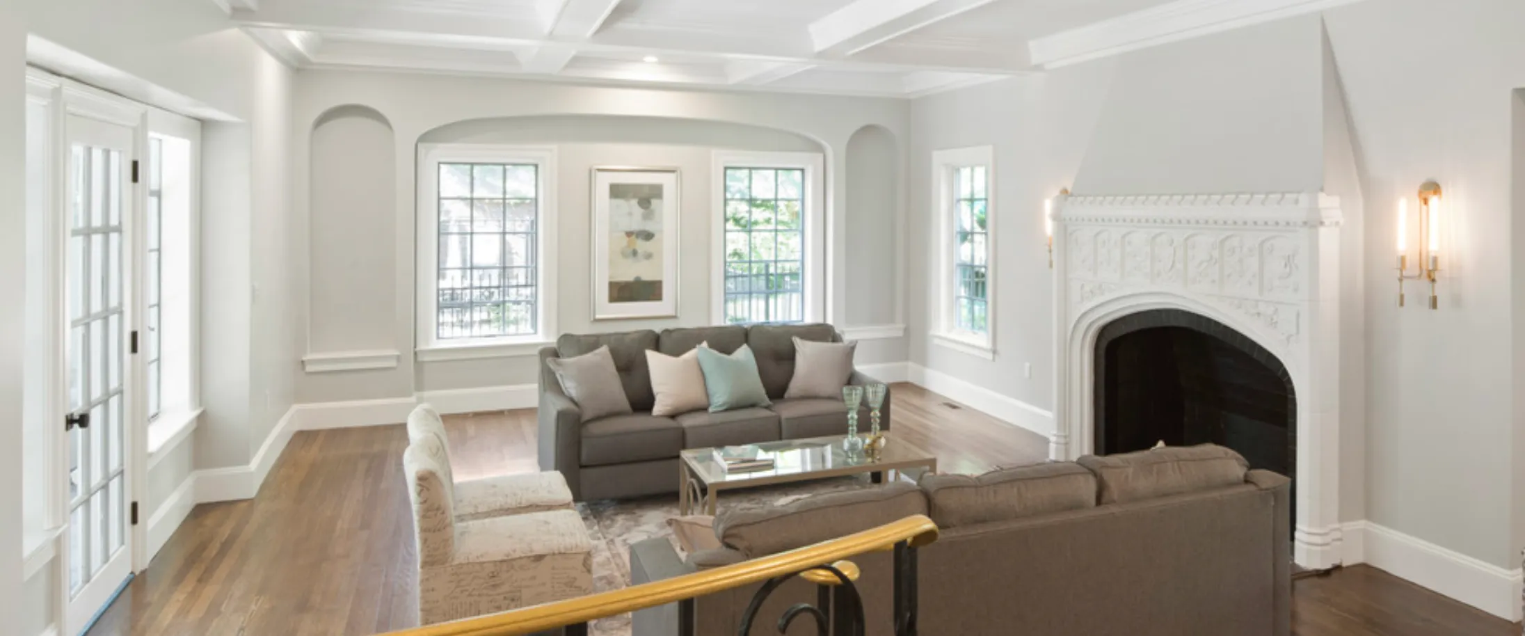 Restored living room with ornate fireplace, Hammonwoods Road project in Chestnut Hill, MA