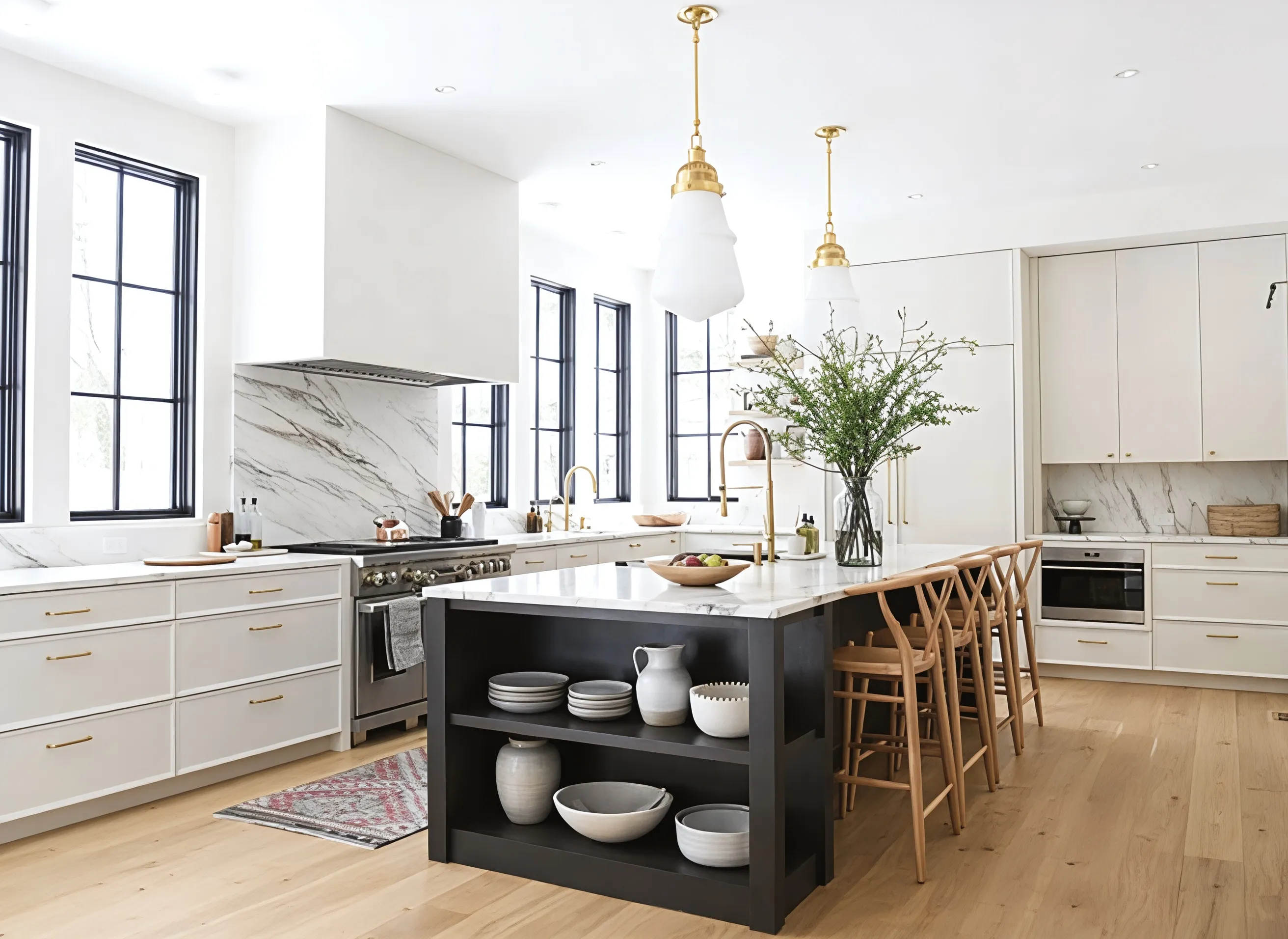Restored kitchen with black island and brass fixtures, Heath Hill Road project in Brookline, MA